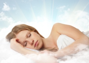 beautiful young woman sleeping on a cloud in the sky